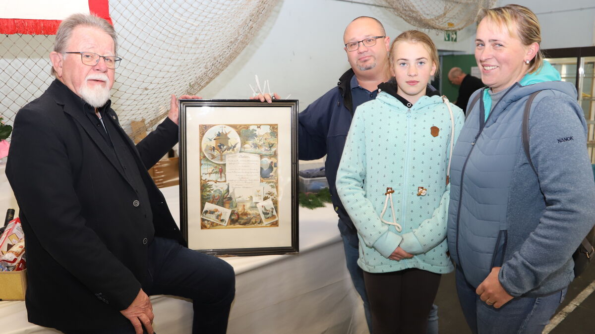 Herbert Henn mit Daniel, Antonia und Anna Czarnecki aus Issendorf, die ein historisches Diplom aus dem Jahr 1898 überreichten. Foto: Witthohn