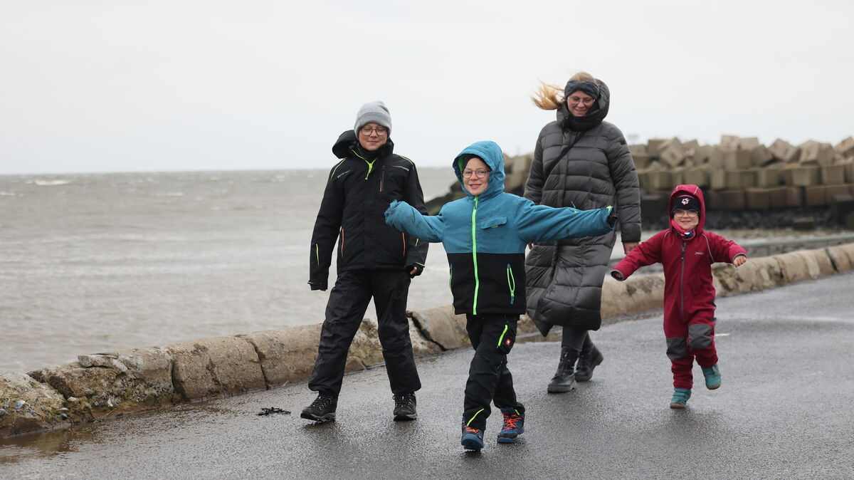 Am Wochenende wird es ungemütlich an der Nordseeküste. Wer vor die Tür muss, sollte sich - wie diese Familie - warm einpacken. Foto: May