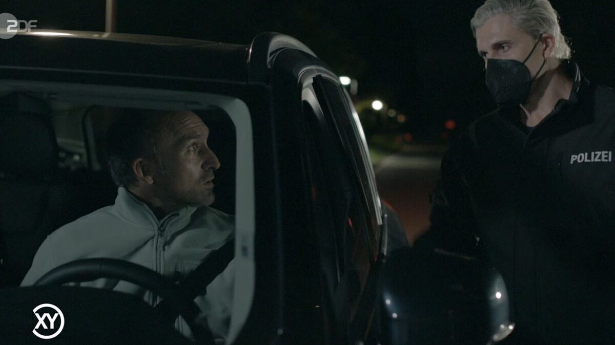 So stellt das ZDF in der TV-Sendung "Aktenzeichen XY..." den beginnenden Raubüberfall dar: Falsche Polizisten stoppen den Fischhändler auf der Straße und täuschen eine Kontrolle vor. Foto: ZDF/Screenshot