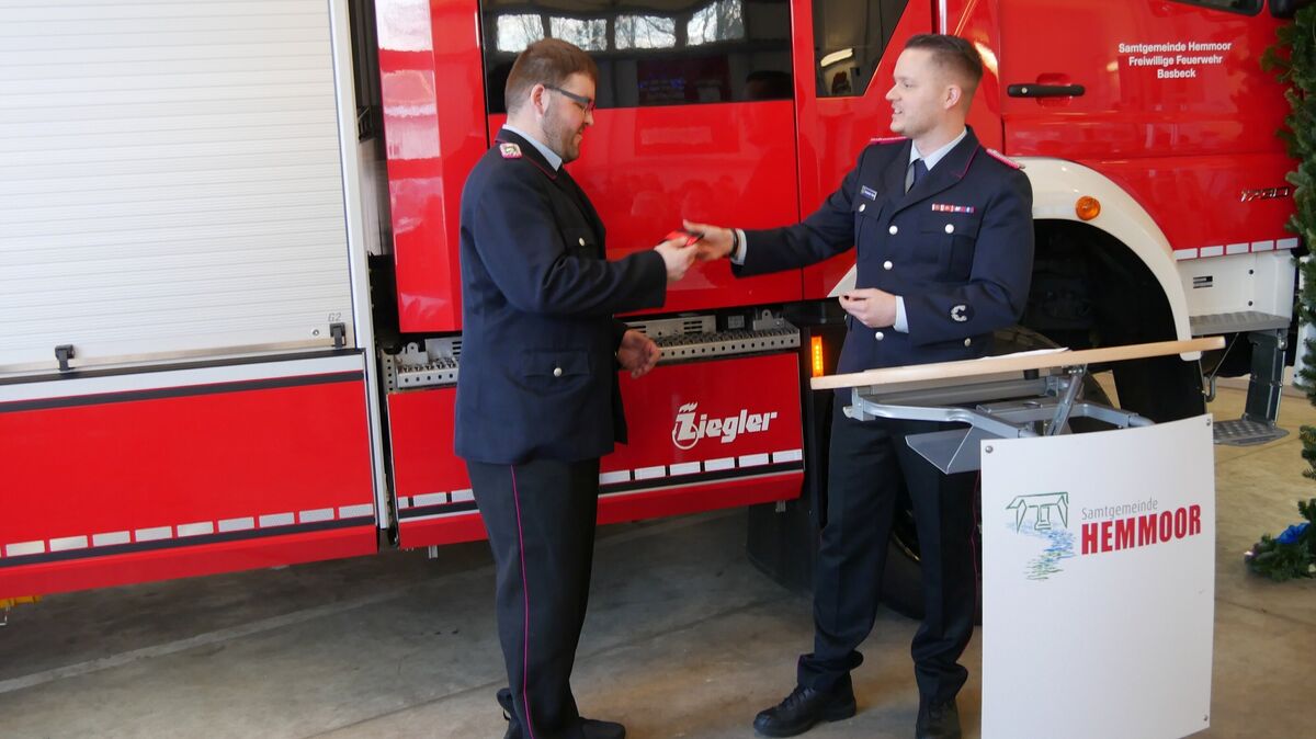 Ortsbrandmeister Alexander Stach reicht den Fahrzeugschlüssel an Gerätewart Till Schlimm weiter. Foto: Lange