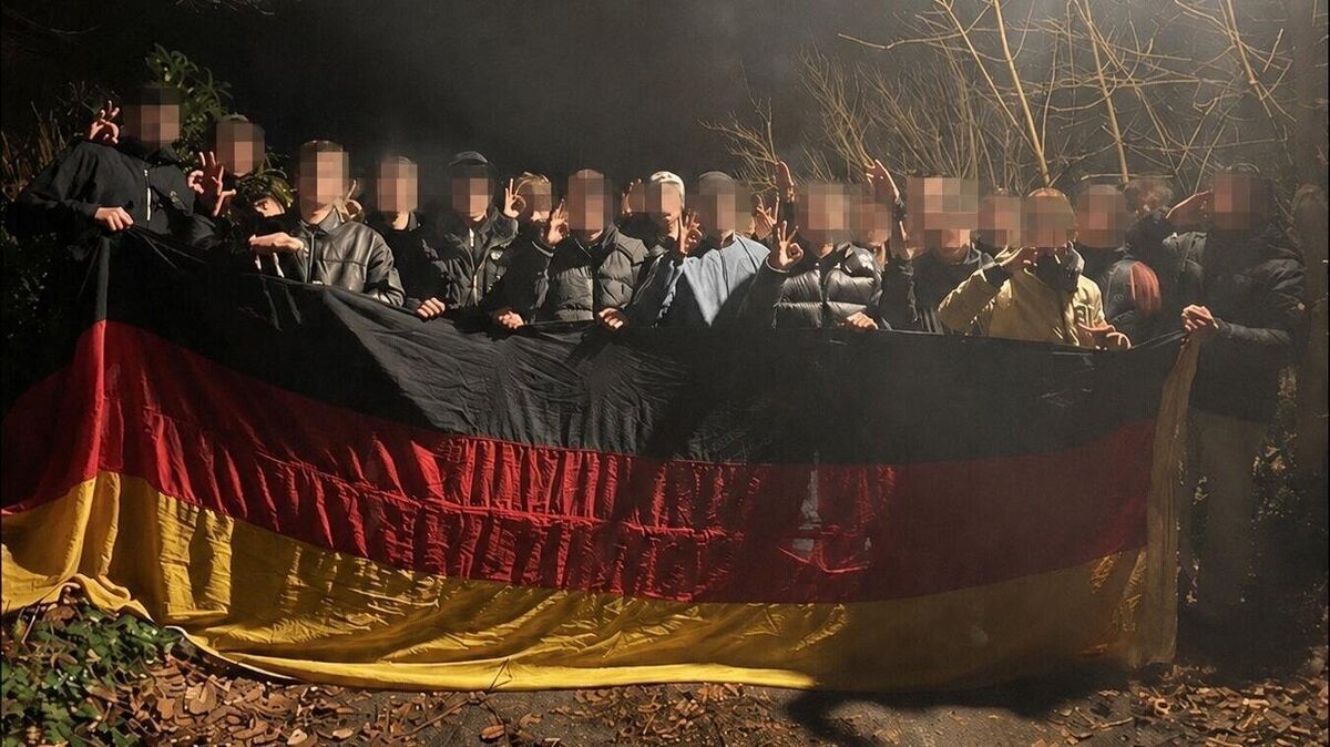 Foto mit politischer Brisanz: Auf der rund zwei Jahre alten Aufnahme posieren mehrere junge Männer, darunter ein Kandidat für den Cuxhavener Stadtrat, nachts im Wald mit Deutschlandflagge und umstrittenen Handzeichen. Die CN/NEZ-Redaktion hat die Gesichter verpixelt. Foto: privat