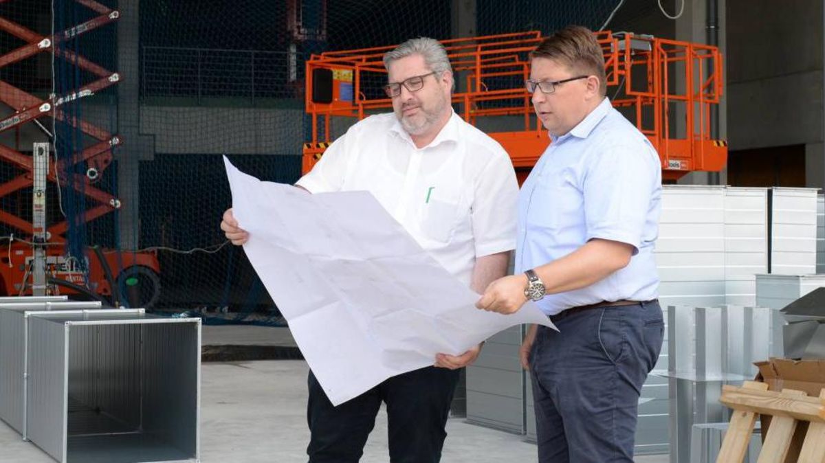 Die beiden Geschäftsführer von Möbel Wohn-Erlebnis Steffens aus Lamstedt, Jörg und Lars Tiedemann (v.l.), studieren die Pläne im neuen Erweiterungsbau.Foto: Schult