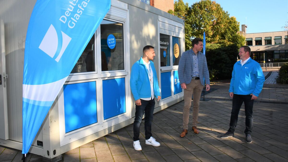 Stefan Ricker (r) und Armend Krasniqi (l.) sind am Info-Container von "Deutsche Glasfaser" in den kommenden Wochen am Rathausplatz in Hemmoor präsent, um Kunden über den Breitbandausbau direkt zu beraten. Das Unternehmen bietet kostenlose Anschlüsse für schnelles Internet an - diese sind aber an Bedinungen geknüpft. Foto: Schröder