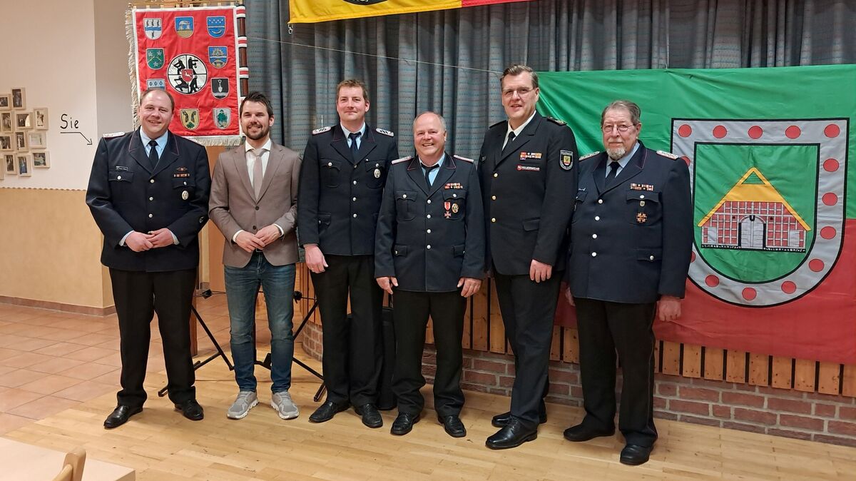 Posieren mit Ehrenortsbrandmeister Johann Söhl (3.v.r.) für das Gruppenfoto: Gemeindebrandmeister Stefan Müller (v.l.), Samtgemeindebürgermeister Frank Springer, Ortsbrandmeister Tobias Steffens, Abschnittsleiter Meik Kramer, Ehrengemeindebrandmeister Hartmut Müller. Foto: Jungclaus
